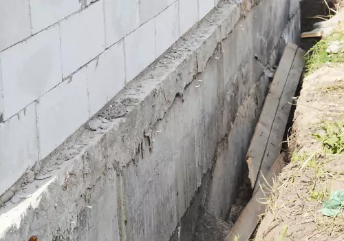 A foundation is seen undergoing repairs. Basement Systems Waterproofing & Foundation is a foundation contractor in Morton IL.