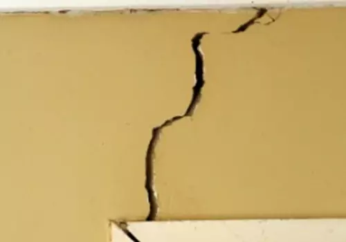 A cracked wall is seen. Heartland, Foundation Contractors in Peoria IL, fix cracked walls.