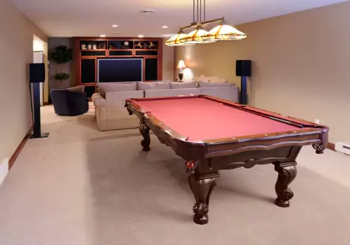 A pool table is seen in a finished basement. Basement Systems Waterproofing & Foundation is among teh best Basement Contractors in East Peoria IL.