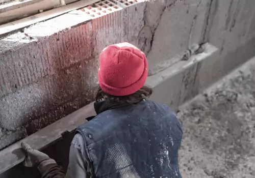 A foundation expert is seen repairing a foundation. Basement Systems Waterproofing & Foundation is one of the best Basement Contractors in East Peoria IL.